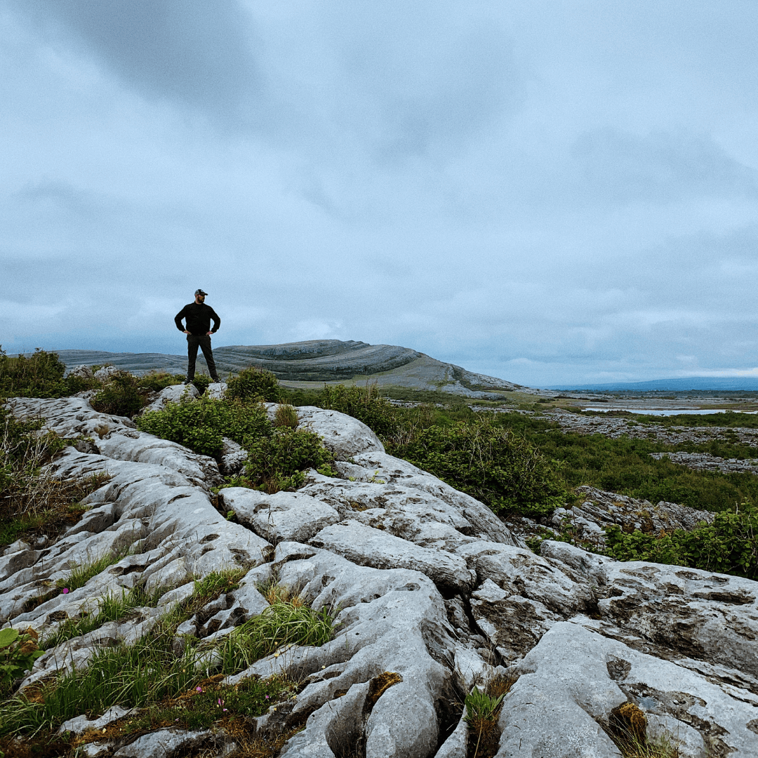 Experienced hiker enjoying the scenic view of the open range on a beautiful day