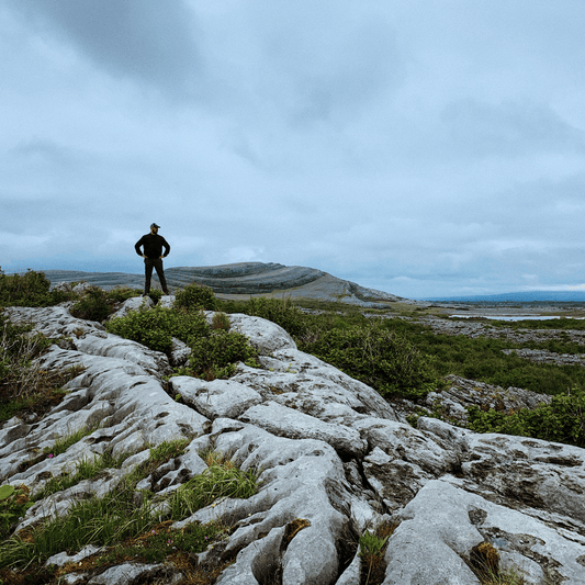 Experienced hiker enjoying the scenic view of the open range on a beautiful day