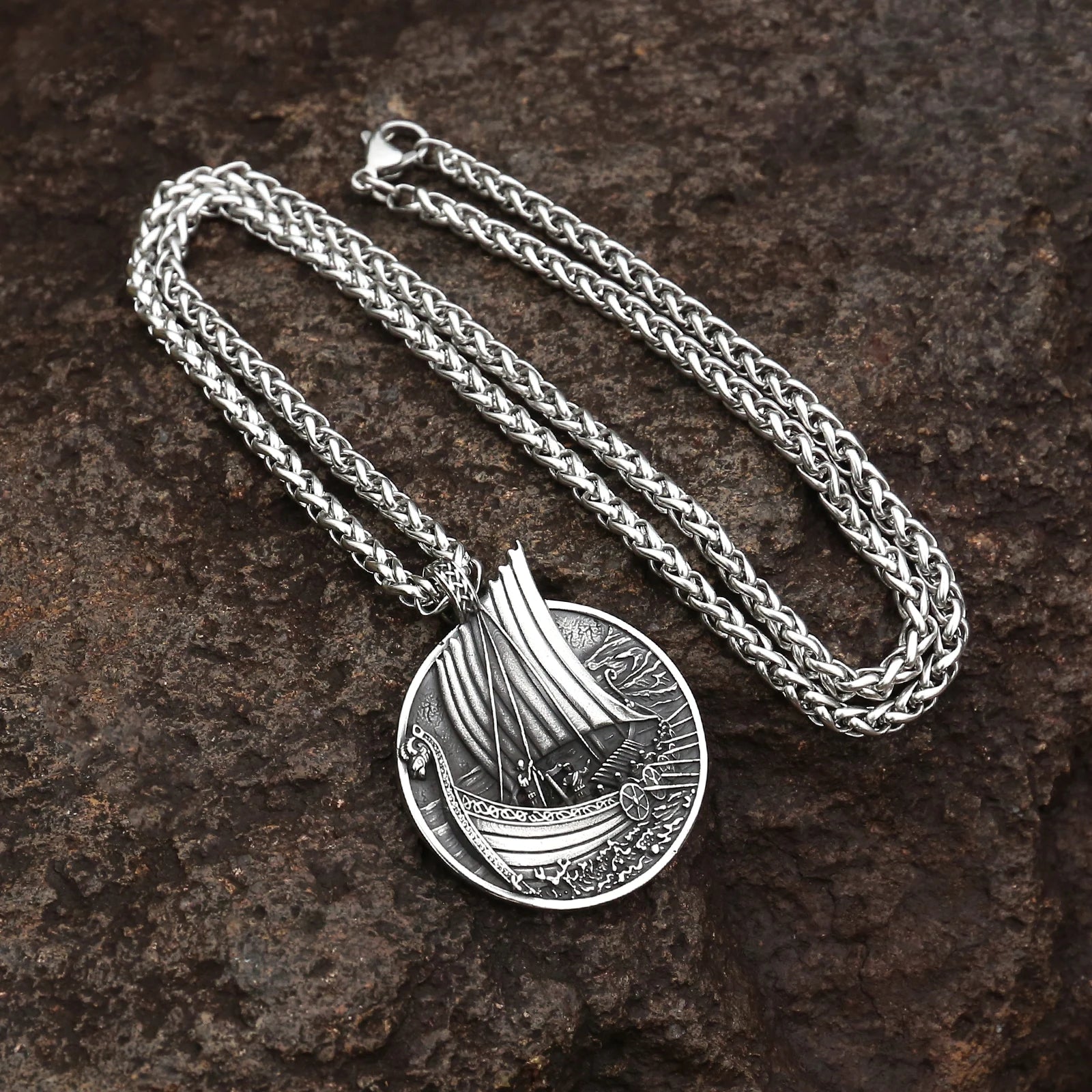 Elegant Voyager’s Crest Viking Long Ship Necklace displayed against a nautical backdrop, emphasizing the 23.6-inch stainless steel chain and 1.18-inch pendant.