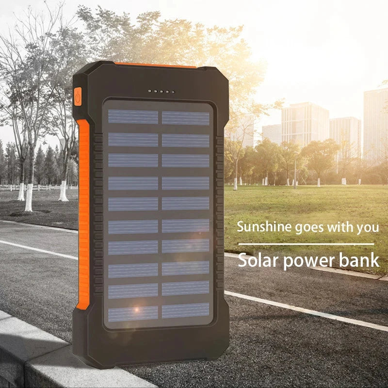 Person using the integrated compass on the Expedition Max 200K Solar Power Bank during a hiking trip, showcasing its practical outdoor application.
