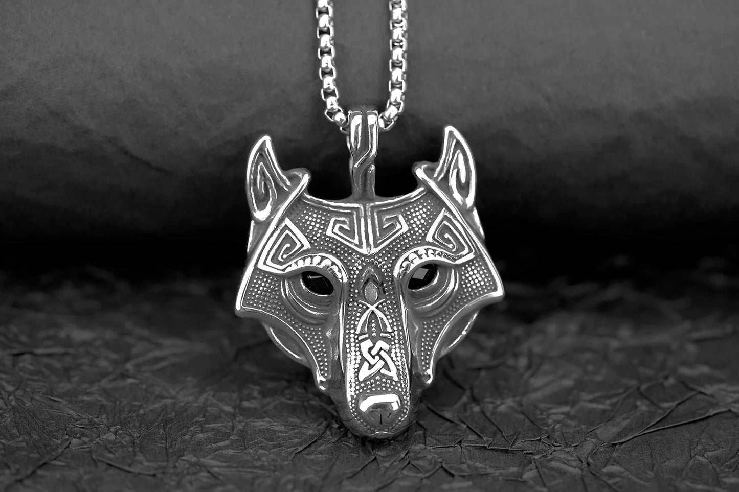Dynamic image of the Fenris Wolf necklace laid out with Viking-themed accessories, enhancing its historical and cultural significance in Norse lore.