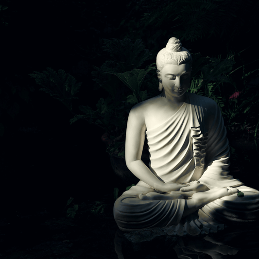 Buddha sitting in serene contemplation amidst a tranquil forest, radiating peace and serenity.