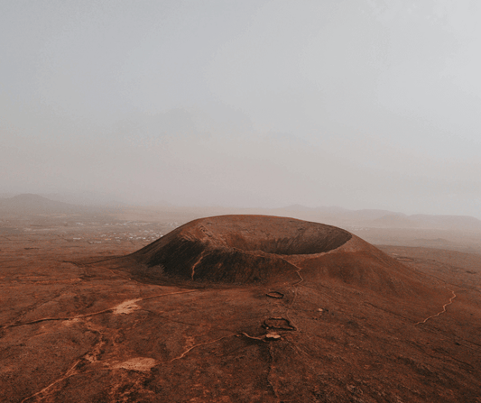 Aerial view of Calderón Hondo Volcano showcasing its majestic crater and surrounding terrain on Fuerteventura Island