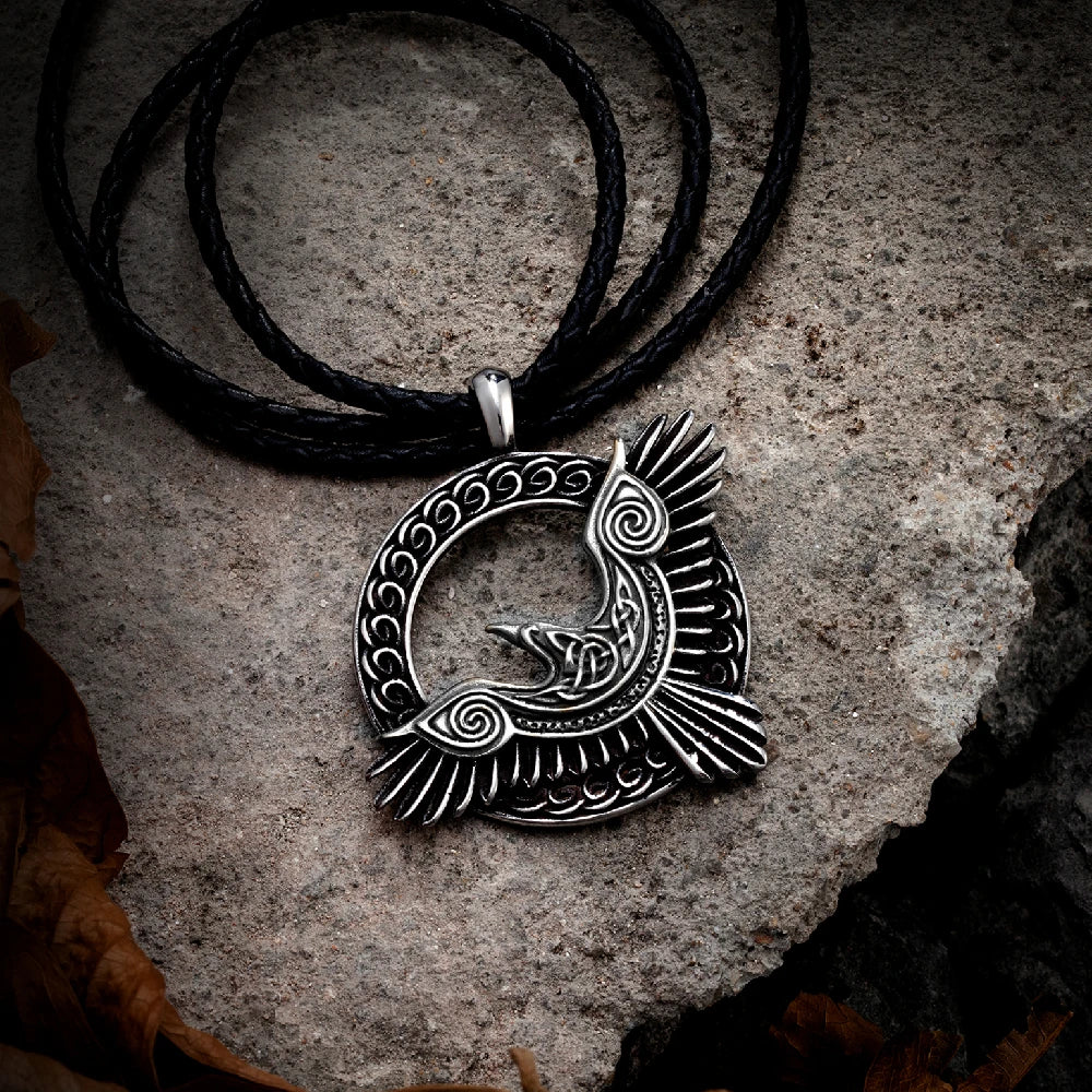 Fashion-forward styling of the Odin’s Raven Flight Necklace with a leather band, worn by a model in an outdoor setting to reflect its rugged appeal.