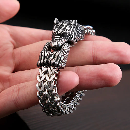 Close-up of a stainless steel bracelet with a clasp depicting the Fenris Wolf biting its tail, showcasing intricate craftsmanship and Viking style.