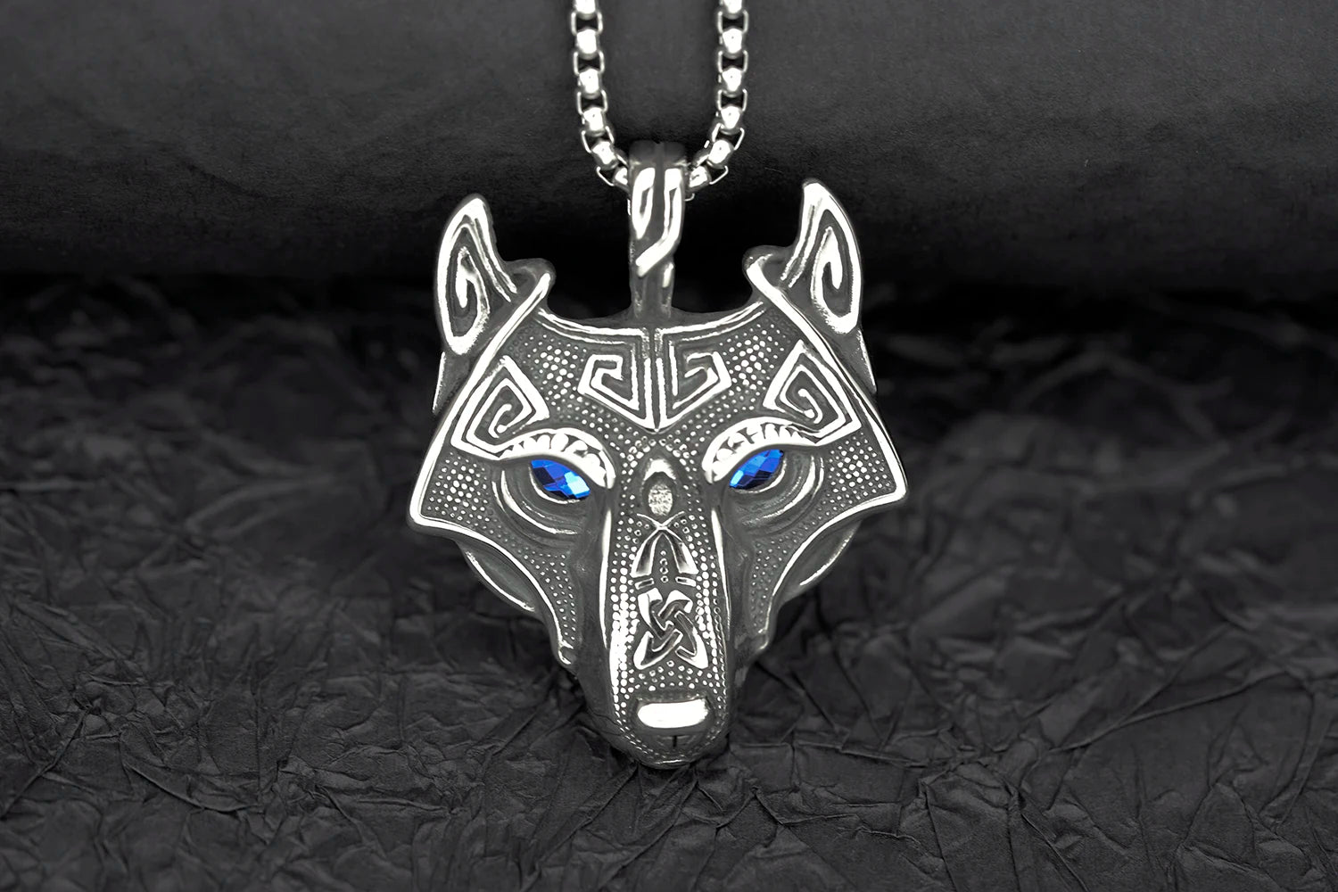 Detailed view of the Fenris Wolf Luminary Pendant showing all four eye color options: blue, green, red, and black, offering customization for personal style.