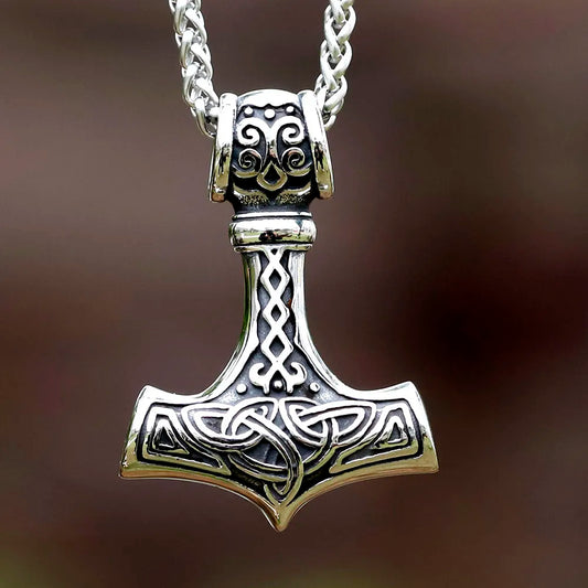 Stainless steel Mjöllnir pendant, Thor's Hammer, with intricate Norse ornaments, hanging on a 23.6-inch chain, symbolizing strength and protection.