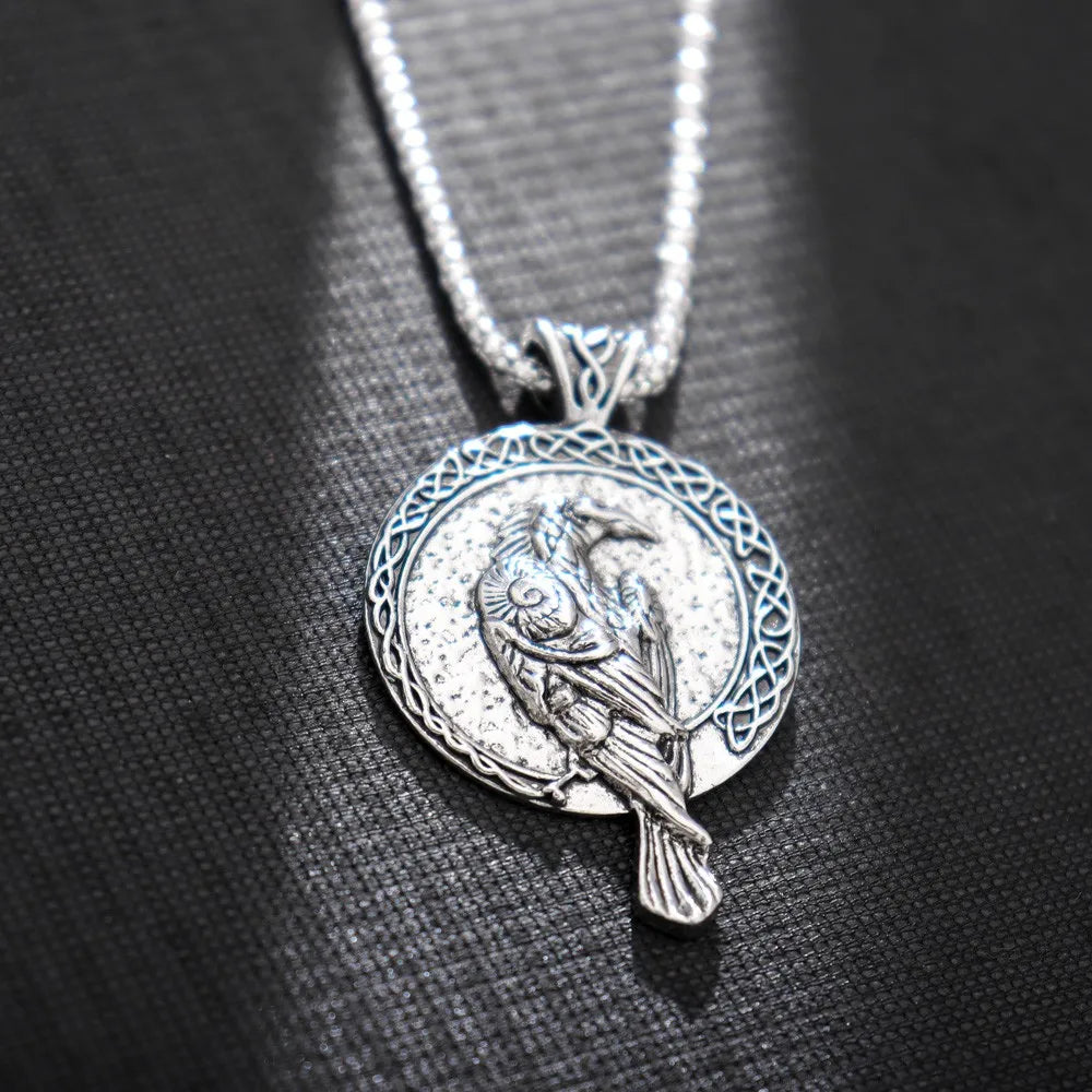 Artistic shot of Odin’s Raven Wisdom Necklace featuring both Hugin and Munin designs, highlighting Norse mythology's deep symbolism.