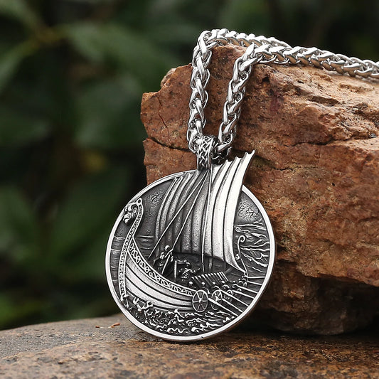 Detailed stainless steel pendant of a Viking long ship on the Voyager’s Crest Necklace, showcasing intricate craftsmanship and historical design.