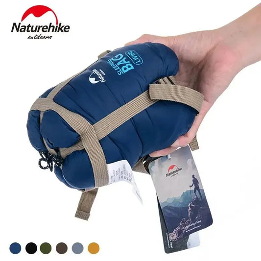 Naturehike Starlite LW180 Ultralight Sleeping Bag displayed in a camping setting, showing its spacious envelope design and vibrant color options.